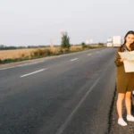 Women standing near white car with map