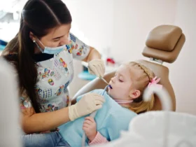 Little baby girl at dentist chair Children dental