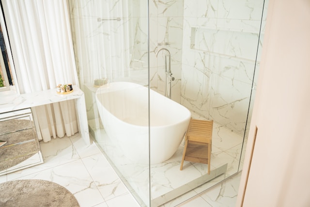 a bathroom with a tub and stool