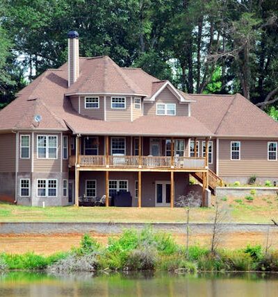 Brown Wooden House Near Forest and Water