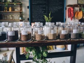 Clear Glass Jars on White Wooden Shelf