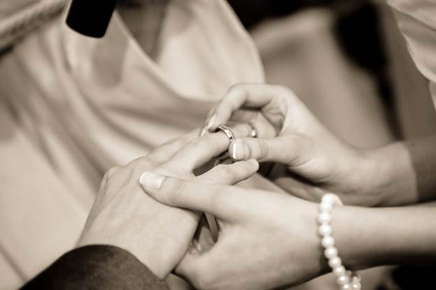 Husband and wife exchanging rings at an engagement ceremony