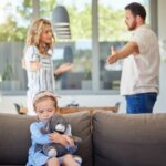parents are talking and at the same time they are pointing at their child