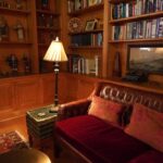 A living room filled with lots of books and furniture