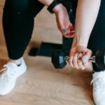 woman training with dumbbell in sport club