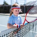Girl Wearing Sportswear Standing by the Tennis Net