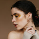 woman wearing huggie earrings