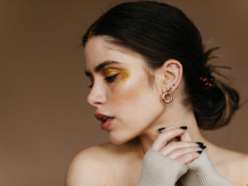 woman wearing huggie earrings